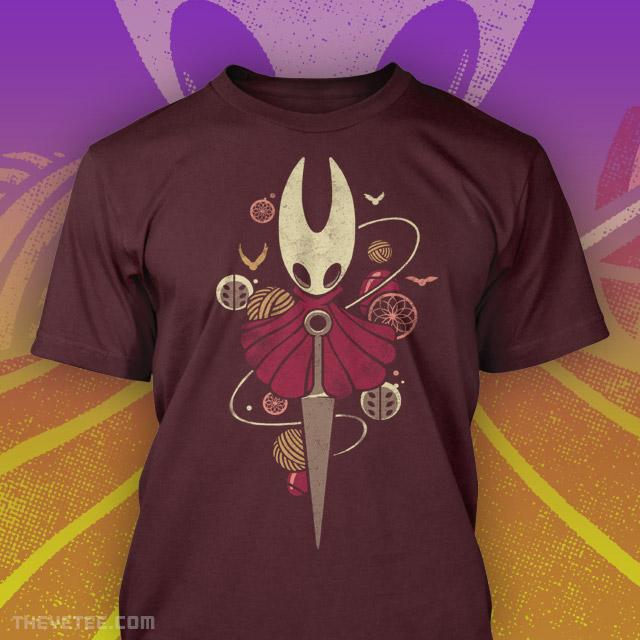 Red tee shirt, the Hornet is centered with a Sharpened Nail. Around them are balls of thread.  - Hornet